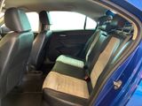 a blue car with a black seat cover in the back of it