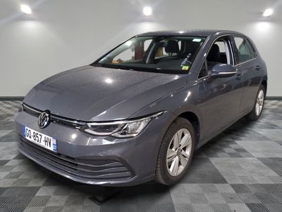 the grey volkswagen golf is parked on a checkered tile floor