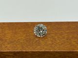 a close up of a diamond sitting on top of a wooden table