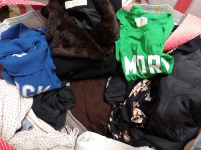 a suitcase filled with clothes and a teddy bear in it
