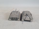 two toy tanks sitting next to each other on a table