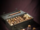 a metal box with various items in it on a table