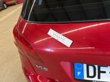 a red car with a sticker on the back of it