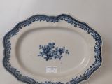 an antique blue and white platter with blue flowers on it