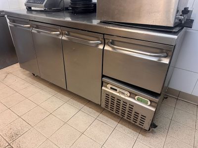 a stainless steel counter top with a dishwasher on top of it