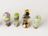 several vases are lined up in a row on a white surface