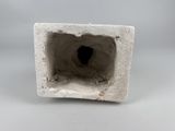 a small white object with a hole in it