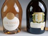 two bottles of wine sitting next to each other on a table