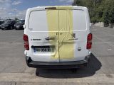 a white van with yellow tape on it parked in a parking lot