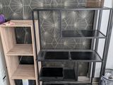 a shelf with a lamp and a bookcase in the corner