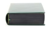 an open book with a green cover sitting on a white surface