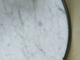 a white marble table with a mirror on top of it