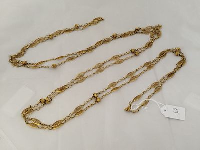 a close up of a gold chain with a tag on it