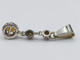 a close up of a pair of earrings on a white surface