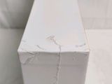 a white box with a chain on it sitting on a table
