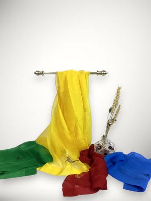 yellow, red, green, and blue scarf hanging on a clothes rack