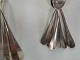 two spoons and two spoon spoons on a table