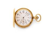 a gold pocket watch on a white surface with a white background