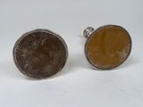 pair of silver and brown stone cufflinks on white background