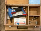 a box with tools inside of it on the floor