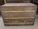 an old wooden chest sitting in the middle of a room