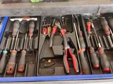 many tools in the drawer of a workbench