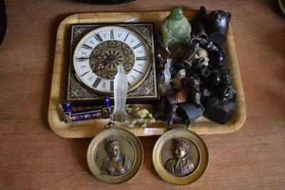a wooden tray with a clock and some figurines on it
