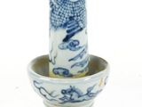 a blue and white vase with a bird on it