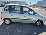 an image of a small car parked in a parking lot