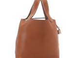 a brown leather handbag on a white background