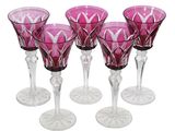 six pink wine glasses sitting next to each other on a white surface