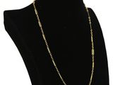 a black mannequin with a gold chain on it
