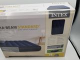an inflatable air mattress in a box on a white surface