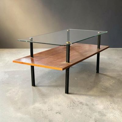 an image of a glass and wood coffee table on a concrete floor