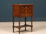 an old wooden table with three drawers and a shelf underneath it