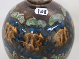 a brown vase with a blue and yellow design on it