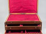 an open wooden box with three drawers on top of it