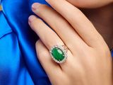 close up of a woman ' s hand with a ring on her finger