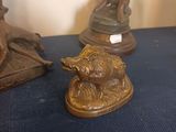 a statue of a man riding a horse next to a statue of a bear