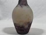 a small vase that is sitting on a white surface