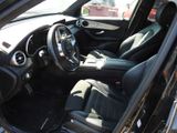 the interior of a car with the door open showing the steering wheel and dashboard
