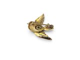 an image of a gold bird brooch with a diamond in its beak