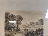 framed picture of a landscape with a village in the distance