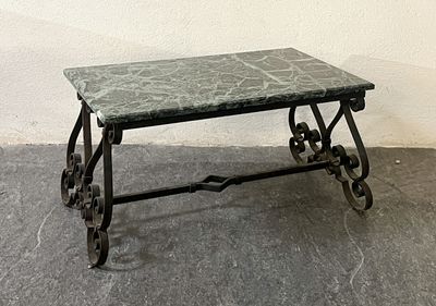 a table with a marble top on wheels on the floor