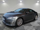 the audi ttr coupe is parked on a checkered tile floor