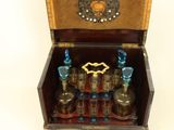a small wooden box with several bottles inside of it