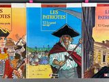 three books that are on a shelf in a room