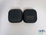 an image of two black chargers sitting on top of a white surface