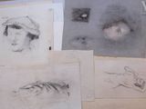 several drawings of a woman and a cat are on a table