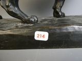 a statue of a horse that is standing on top of a table
